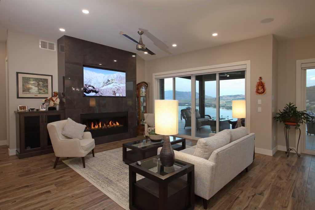 Photo of living room with tiled linear gas fireplace.