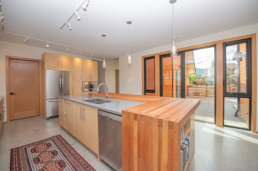 Photo of kitchen with full waterfall butcher block top.