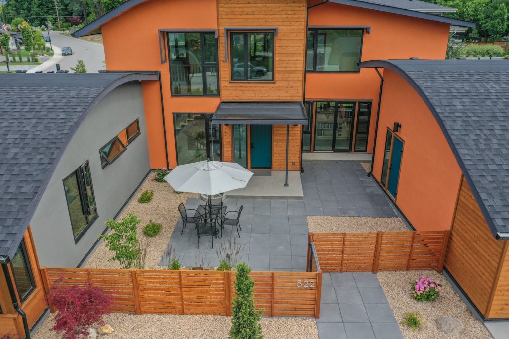 Photo of courtyard with custom solar shade eyebrows over exterior windows.