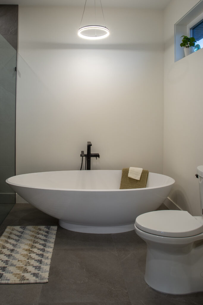 Freestanding bathtub in a modern bathroom with sleek design and minimalist decor.
