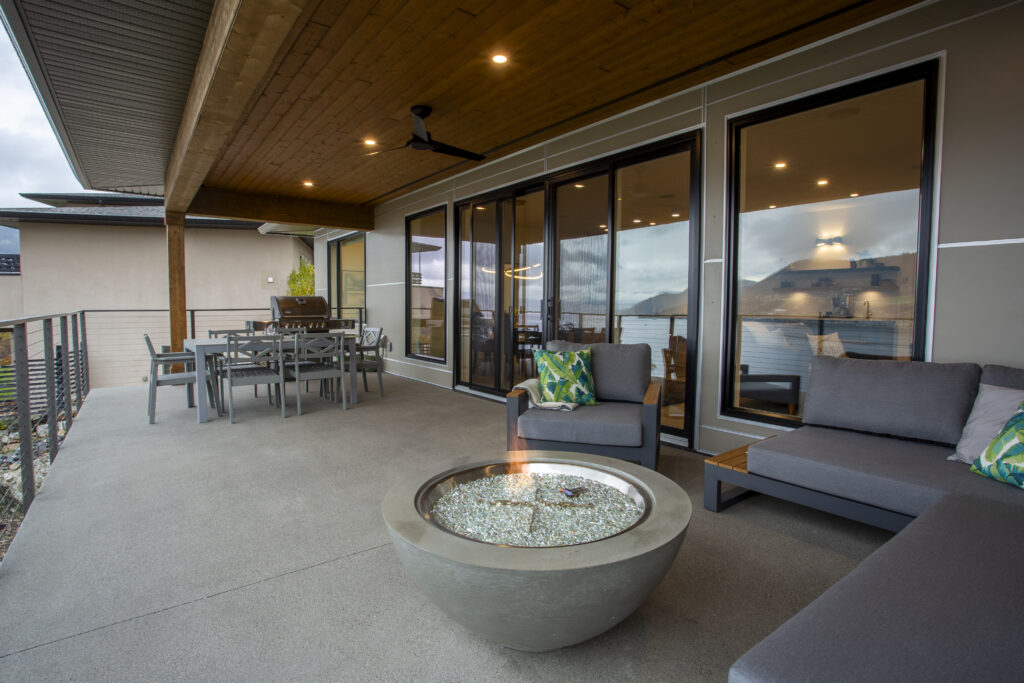 Outdoor seating area with a sectional sofa, fire pit, and view of the surroundings.