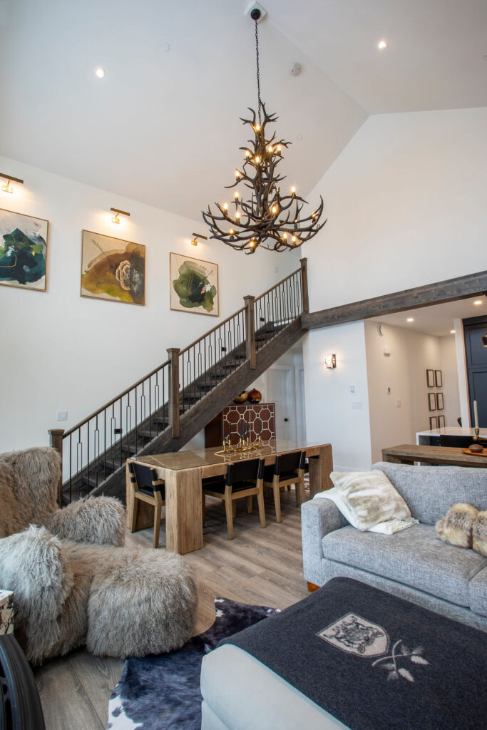 Image of the wooden staircase leading to the upper floor with sophisticated decor elements.