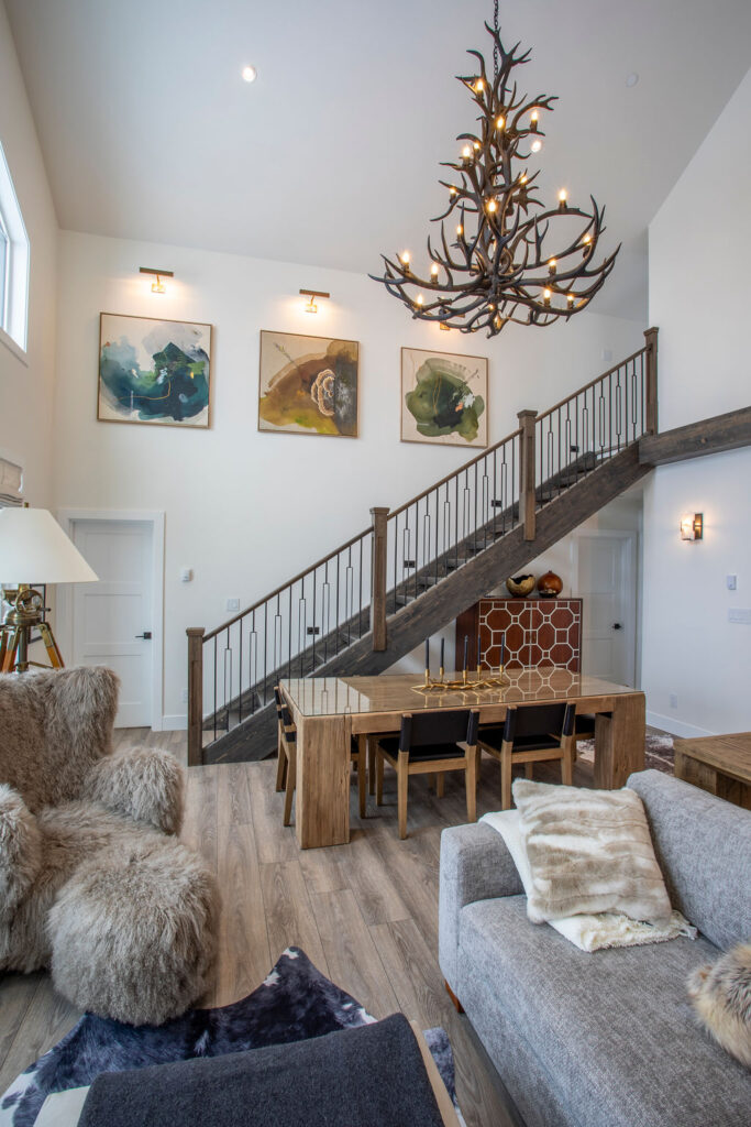 Image of a staircase leading to the upper level with modern wooden railing.