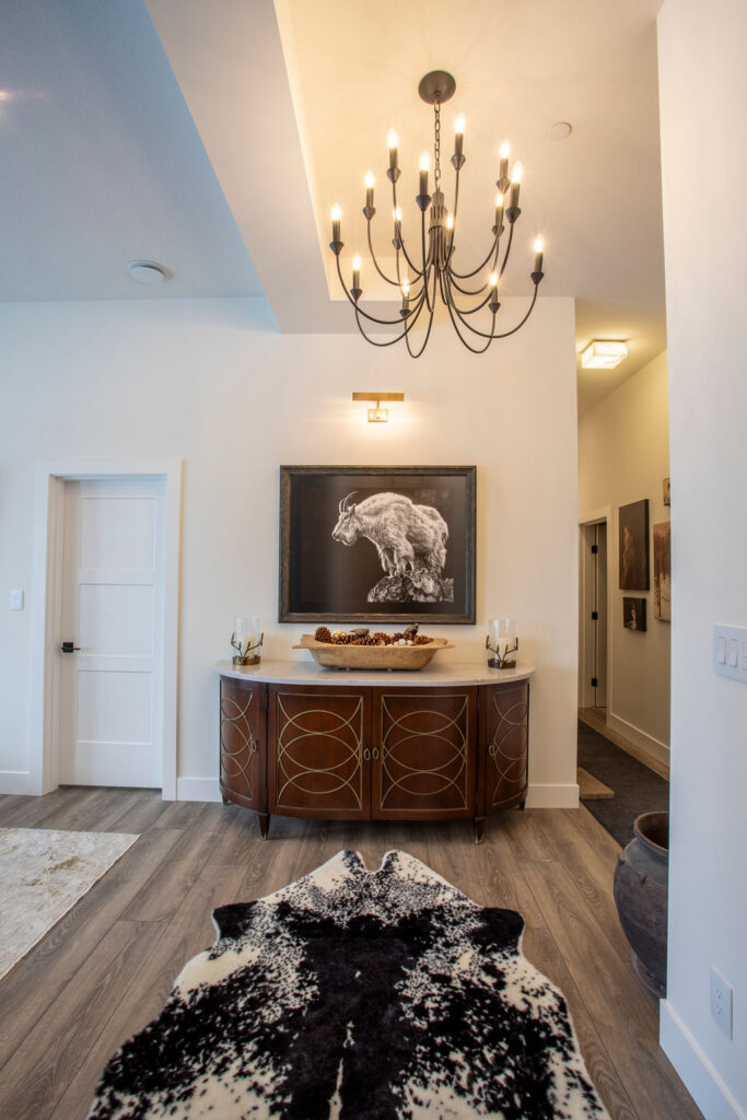 Cozy lounge area with a fur blanket on the couch and a TV mounted above a fireplace.