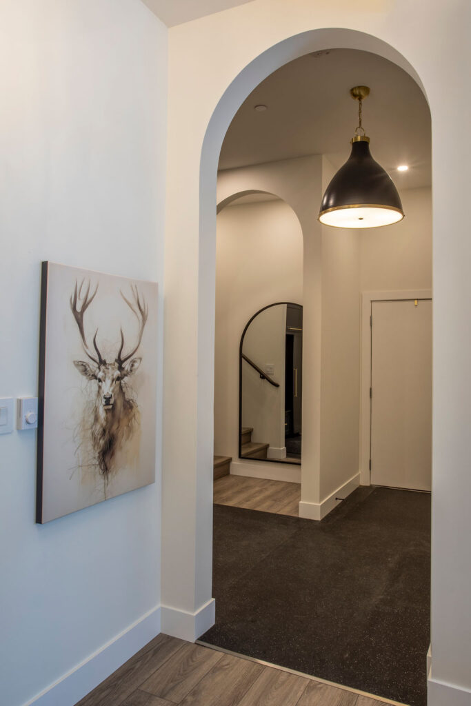 Entryway with coat hooks and storage space for jackets and winter gear.