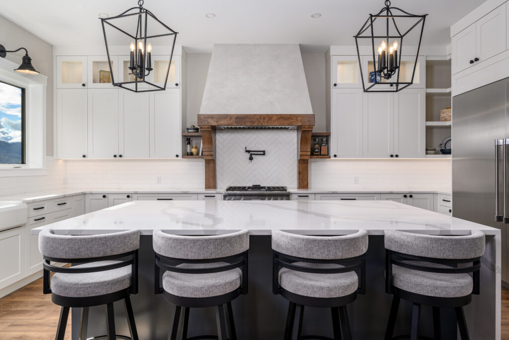 Large kitchen island with seating and rustic modern design in Vernon custom home.