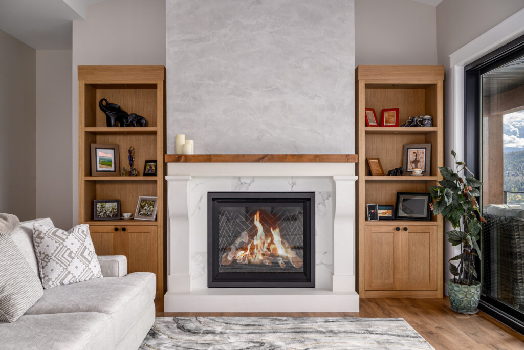 Elegant living room with a stone fireplace, built-in shelving, and warm wood tones.