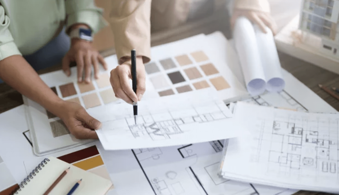 Modern custom home with wood and dark metal siding, large windows, and a spacious driveway, built by Keith Construction in Coldstream, BC.